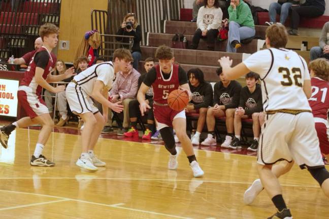 Newton's Dominic Celi maneuvers the ball on the court.