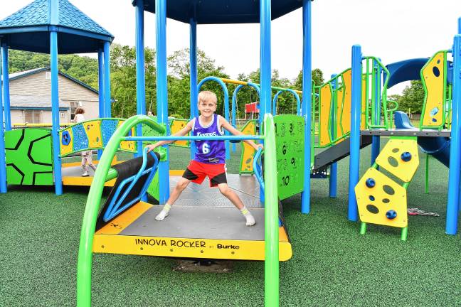 Inclusive playground opens Patrick Rixon tries out the new equipment. (Photo by Maria Kovic)