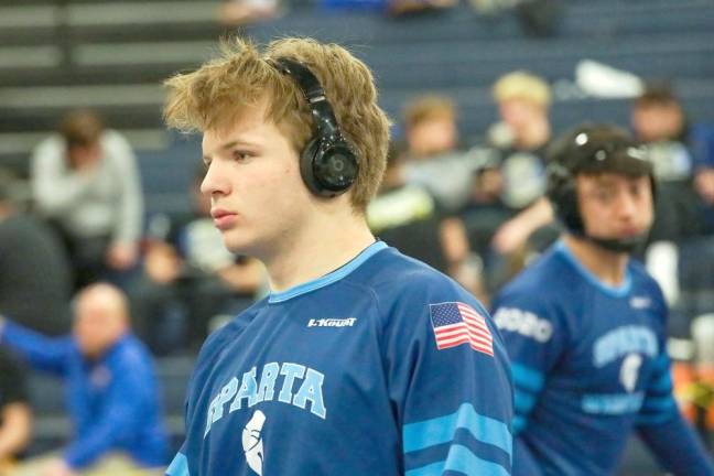 Troy Schmitzer mentally prepares for his match while teammate Nick Hwang looks on.