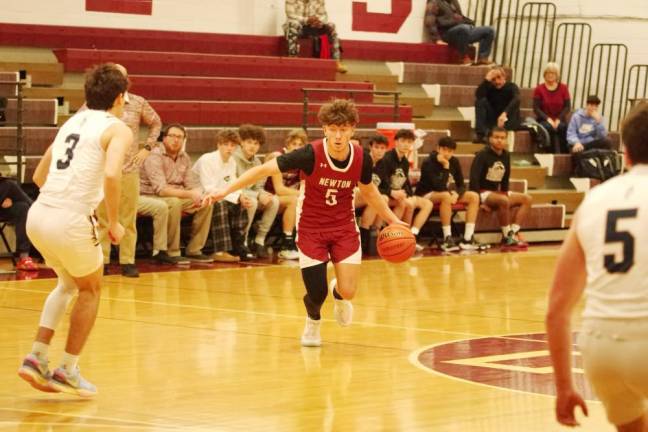 Newton's Dominic Celi handles the ball in the first half. He scored two points.