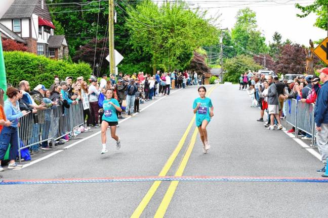 Photos: Girls on the Run 5K Penelope De Valence, 15, finishes second with a time of 22:51.44 followed by Kayla Fortunato, left, 11, with a time of 22:54.52. Both girls are from Ridgewood.