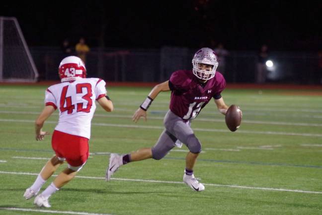 Newton Braves keep rolling Newton quarterback Michael Freda runs out of the pocket to avoid Whippany Park linebacker Cooper Dimmick (43) in the first quarter. Freda gained 51 yards rushing.