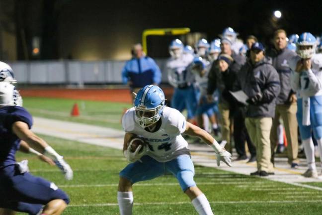 Wide receiver, Colby Plotts, defends the ball against the Randolph Rams as he is just yards from the end zone.