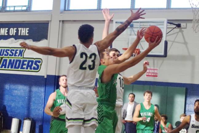 Ocean County's Carson Glenn Francisco takes the ball towards the hoop under tight coverage by Sussex County defenders in the second half. Francisco scored 10 points.