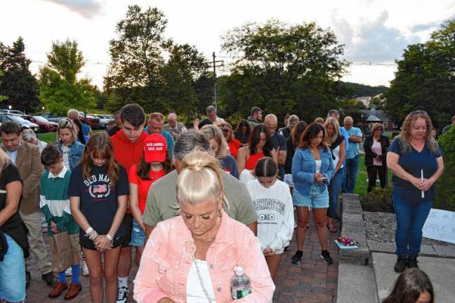 UPDATED: Action on flags attracts criticism Residents bow their heads during a vigil Sunday, Sept. 14 in Sparta for Charlie Kirk, who was shot and killed Wednesday, Sept. 10 while speaking on a college campus in Utah. (Photo by Maria Kovic)