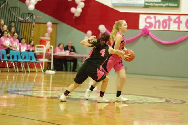 High Point prettier in pink than Newton A Newton Brave handles the ball as a High Point Wildcat reaches in.