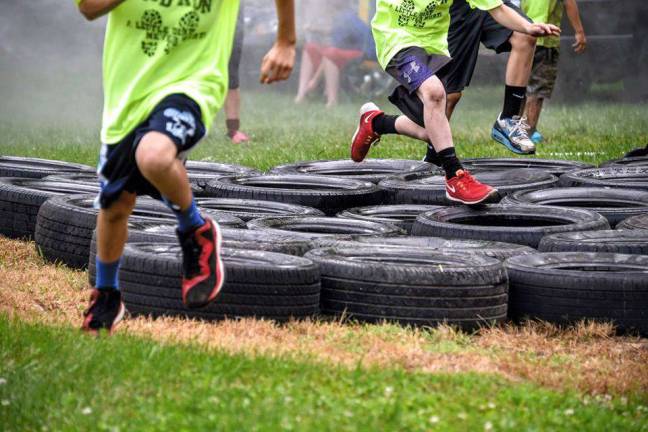 Getting dirty for a great cause Navigating the tires as part of Sunday's Mud Run held at Sparta Evangelical Church.