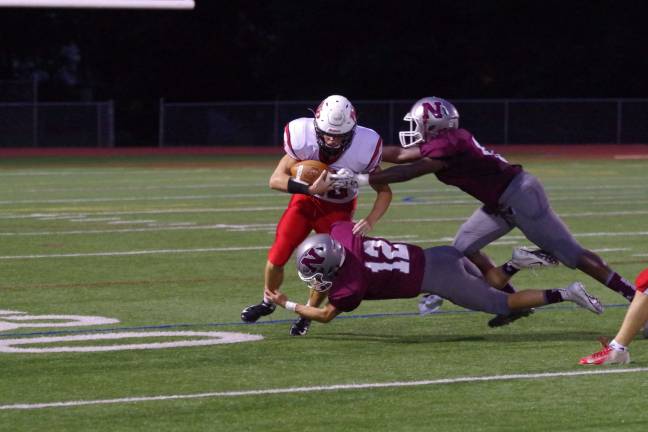 Newton Braves keep rolling Newton defenders grab Whippany running back Matthew Peck in the first quarter.