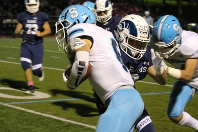 Wide Receiver, Colby Plotts, defends the ball against the Randolph Rams as he is just yards from the end zone.