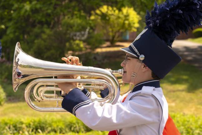 A member of the Lenape Valley Regional High School marching band blows a big horn.