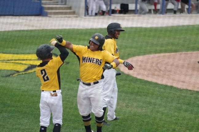 Miners bury Jackals on the diamond Miner Martin Figueroa (center) celebrates with teammates after hitting home run.