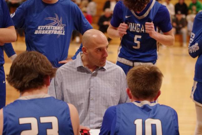 Kittatinny Regional High School head basketball coach Mike Lupo speaks to players during a timeout.