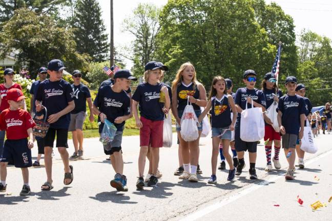 members of local sports teams toss candy during the parade.