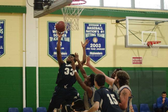 Camden downs Sussex in men's hoops Camden's Emmanuel Abimbola leaps high with the ball during a shot attempt in the first period.