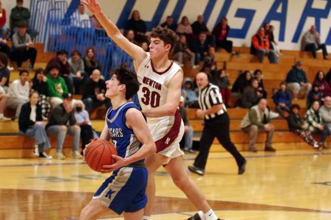 NK1 Kittatinny's Jesse Waldron handles the ball while covered by Newton defender Maxwell Maslowski in the Dec. 22 game, which Newton won, 61-48. Waldron scored two points, grabbed three rebounds and made four steals. (Photos by George Leroy Hunter)