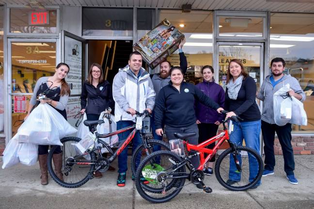 Photo studio provides Christmas gifts for 85 children From left; Alison Turkel, Emily Schuch, Eddie Matias, Kenny Clay, Dayana Orella, Kelly Tomzick, Alison Paling and Brian Levitsky
