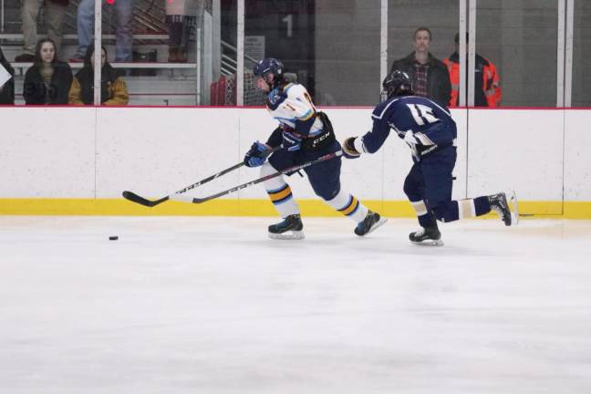 In the first period Sparta-Jefferson's Matthew Espinosa is in control of the puck while Roxbury's Brian Westergaard trails behind. Espinosa scored Sparta-Jefferson's only goal.