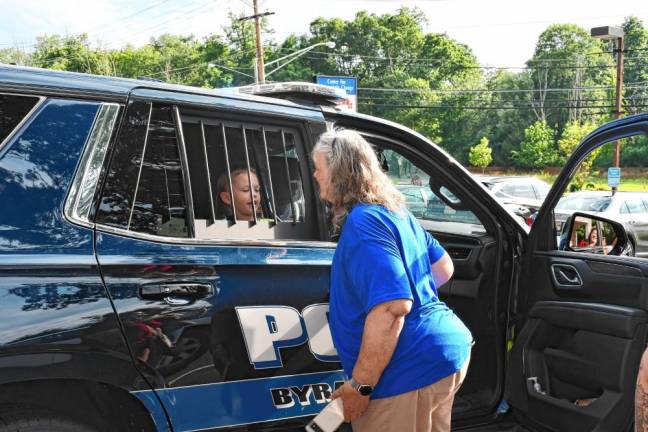 Cones with a Cop in Byram A boy checks out the inside of a police car.