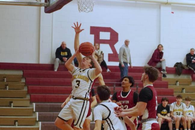 West Milford's Nash Appell takes the ball to the hoop during a shot. He scored two points.