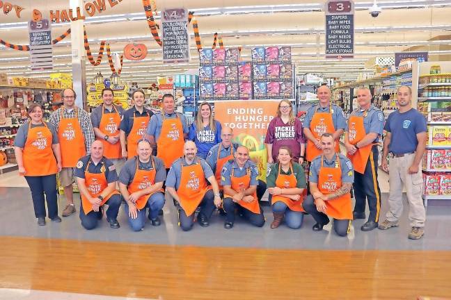 Ending Hunger Together was the theme of a recent event in which volunteers from police, fire, and EMS bagged groceries to raise awareness of the need to end hunger locally.