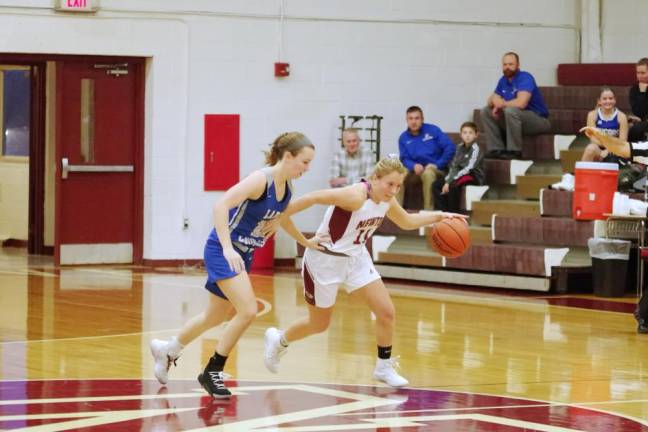 Newton's Olivia Buckley handles the ball while covered by Kittatinny's Maddie Beyer in the third quarter. Buckley scored 8 points. Buckley also grabbed 1 rebound and made 7 assists.