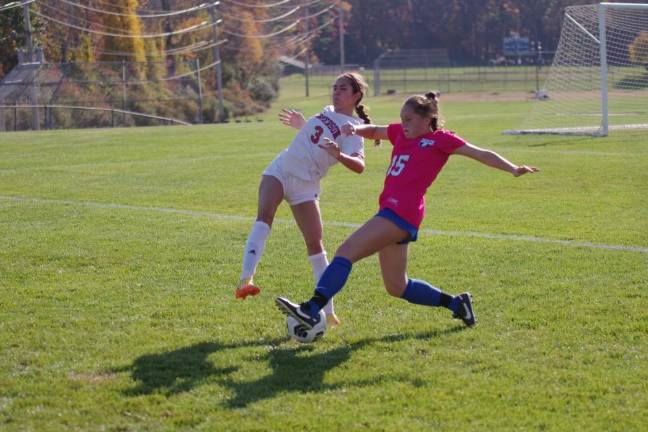 A Kittatinny Cougar and a Emerson Cavalier battle for control of the ball.