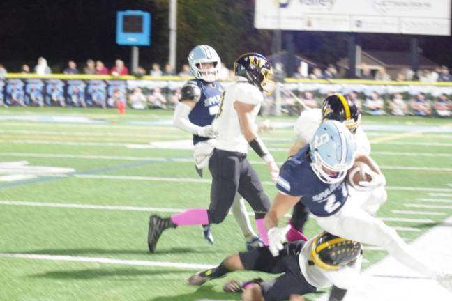 Sparta ball carrier Lucas Brown is knocked out of bounds by a West Milford defender in the first half.