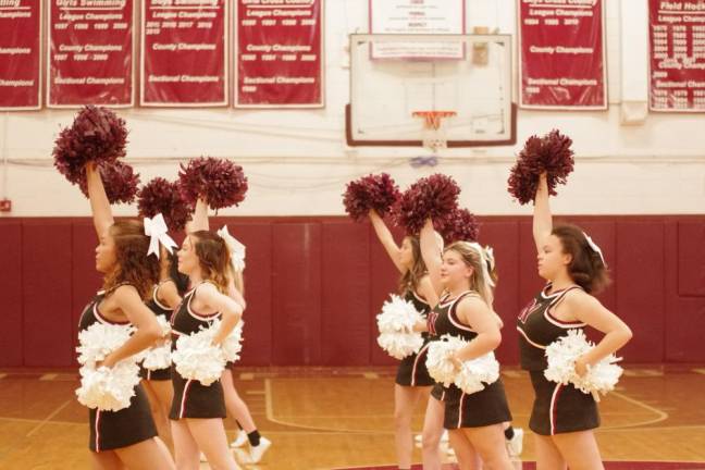 The Newton High School cheerleaders perform during a break in the game.