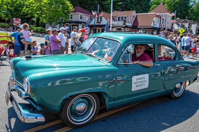 Sparta. Fourth of July events A Sparta Historical Society member in an old-fashioned car.