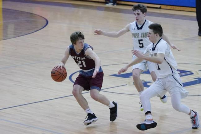 Newton's Aaron Fantasia handles the ball as Pope John defenders approach in the third quarter. Fantasia scored 19 points.