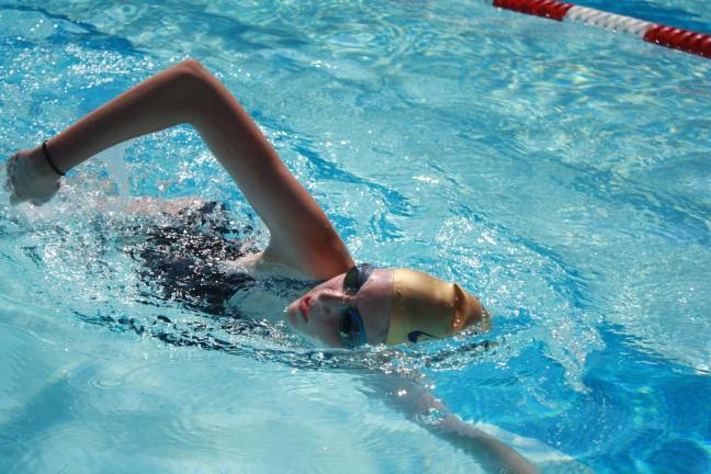 Swim-a-thon to benefit youth group Mikayla Flanz of the Lake Mohawk Hawks completing laps at last Friday’s swim-a-thon fundraiser for Pass It Along.