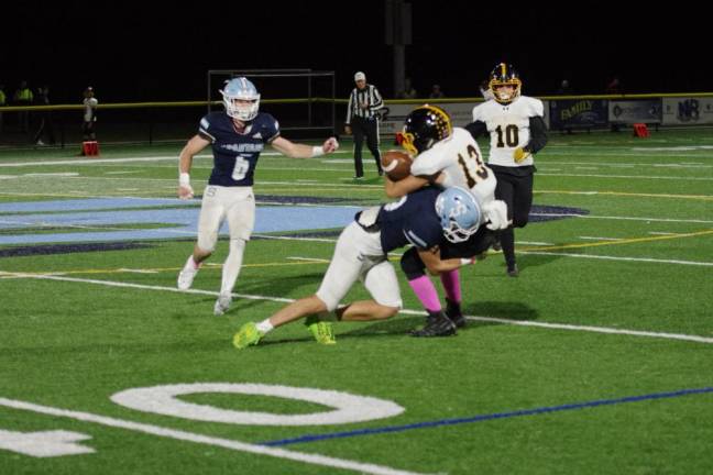 After catching the ball West Milford wide receiver Jake Schwarzlow is taken down by a Sparta defender in the first half.