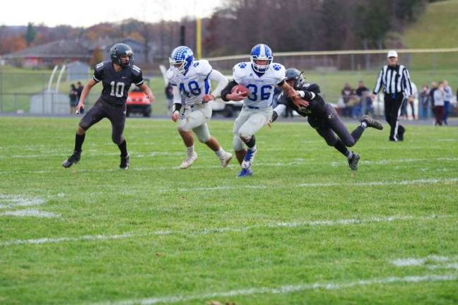 KRHS defeats Wallkill in football Zach Mafaro advances the ball as Wallkill Valley defender Peter Mastroianni dives towards him.