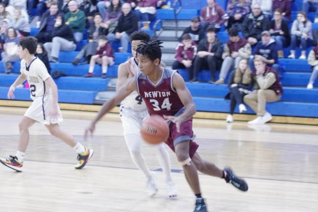 Newton's Donovan Thomas is on the move with the ball in the second quarter. Thomas scored 7 points.