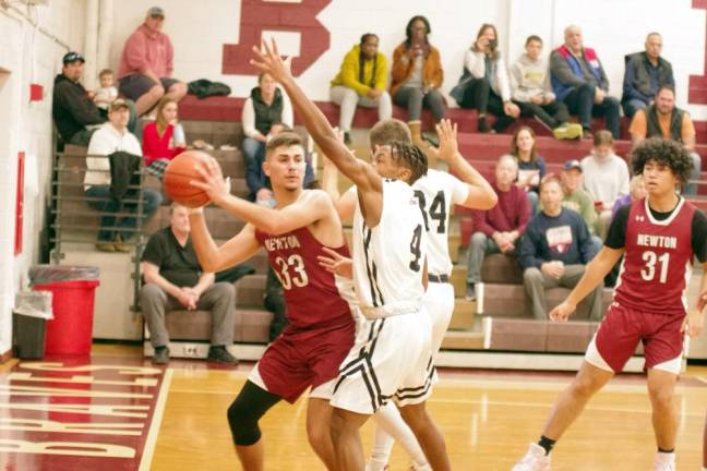 NW2 Newton's Jack Hunterton handles the ball while double teamed.