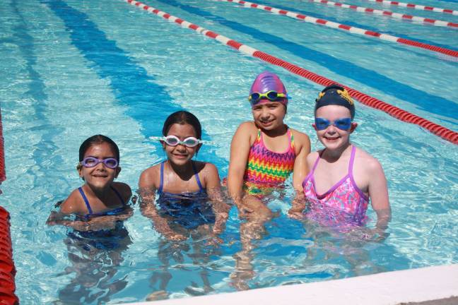 Swim-a-thon to benefit youth group Mila Saluja, age 6, Yana Saluja, age 8, Noel Guerrini, age 7 and Brooke Shust, age 7 take a break for a photo in-between laps.