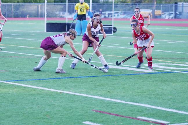 Newton Braves and Belvidere County Seaters are focused on the ball in the second period.