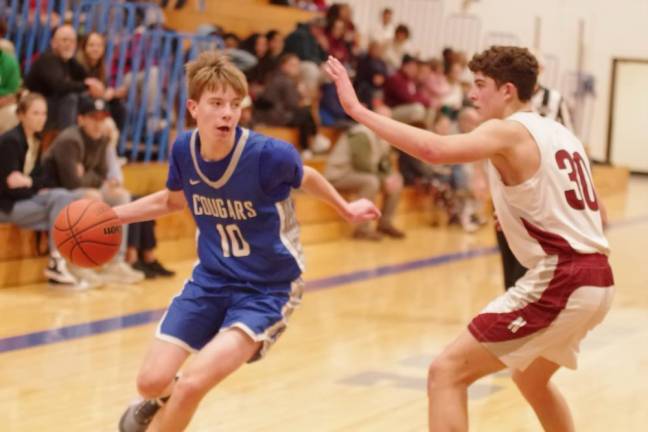 NK2 Kittatinny's Joseph Allison handles the ball while covered by Newton defender Maxwell Maslowski. Allison scored six points, grabbed four rebounds and made two steals.