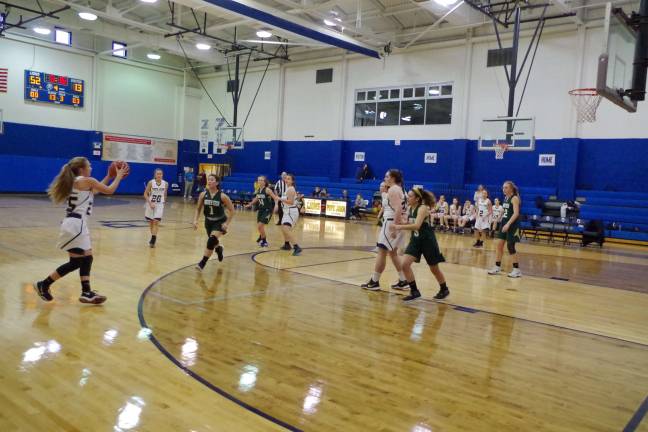 The Pope John Lions and the Sussex Tech Mustangs maneuver on the hardwood.