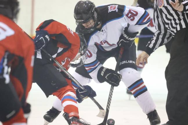 Junior Ty Dellicker (50) of N/LV battles for the puck on a faceoff.