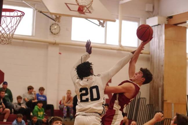 NW1 Newton's Maxwell Maslowski is fouled by North Waren's Christian Otufale (20) in the second period. Maslowski scored 22 points in the game. (Photos by George Leroy Hunter)