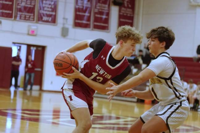 Newton ball handler Cooper Armstrong faces West Milford defender Tyler Liguori.