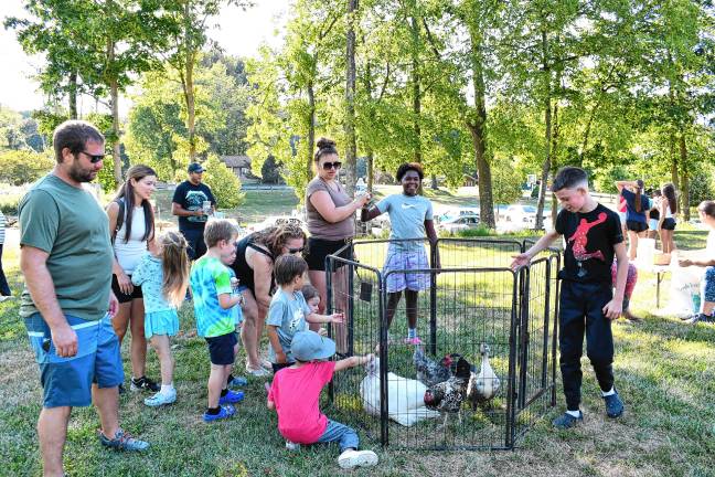 Photos: Byram Fest Children look at animals in the petting zoo.