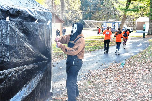 Photos: Haunted Hawk Hustle 5K Zach Doyle of Newton, wearing a ‘Scream’ mask, greets participants at the Haunted Hawk Hustle 5K and one-mile Fun Run on Saturday, Oct. 11 at the Hampton Pit in Newton. (Photos by Maria Kovic)