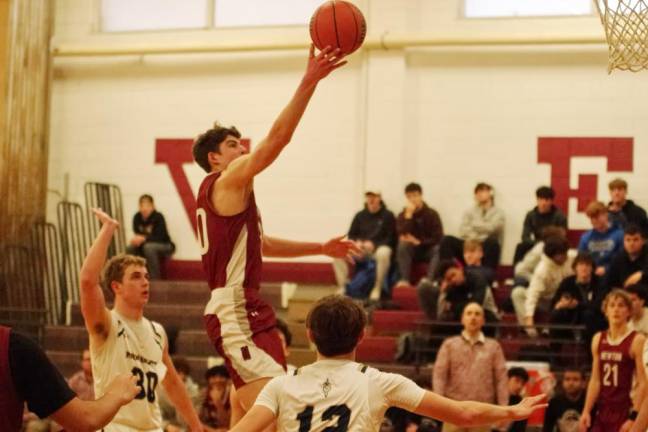 NW3 Newton's Maxwell Maslowski raises the ball toward the hoop during the second half. He scored 19 points in the game against Roxbury.