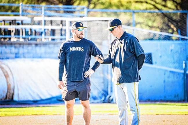 Gavin Stupienski, left, a player-turned-coach, watches the tryouts with Miners manager Chris Widger, who is starting his second season with the team.