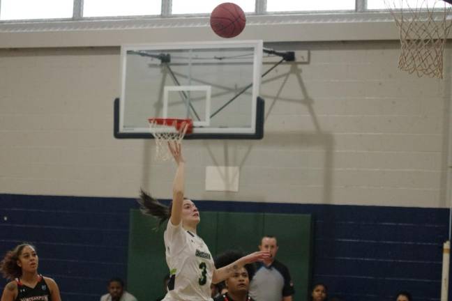 Sophia Brondo of SCCC tosses the ball toward the hoop. She scored three points.