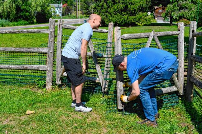 Photos: Volunteer Day at Rebecca’s Homestead <b>Jason Bailey and Mark Stoller, volunteers from Selective Insurance, fix a gate at Rebecca’s Homestead in Branchville. (Photos by Maria Kovic)</b>