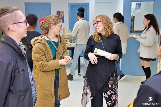 Dianna Morrison speaks with attendees at the EPIC Gallery opening.