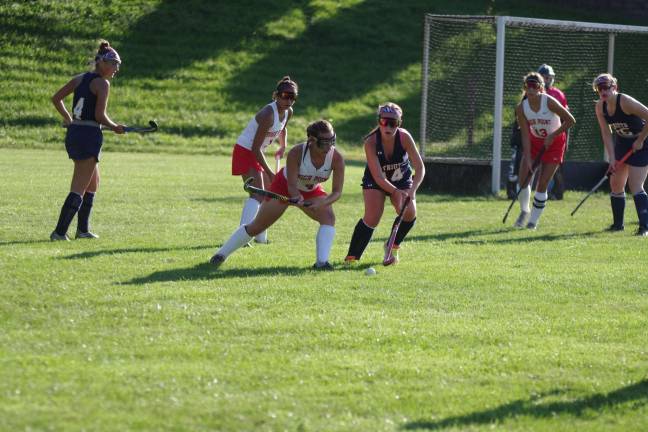 High Point tops LVRHS in field hockey opener High Point's Michaela Thiessen begins to swing her stick at the ball as Lenape Valley's Jayna Rode uses her stick to reach towards it.